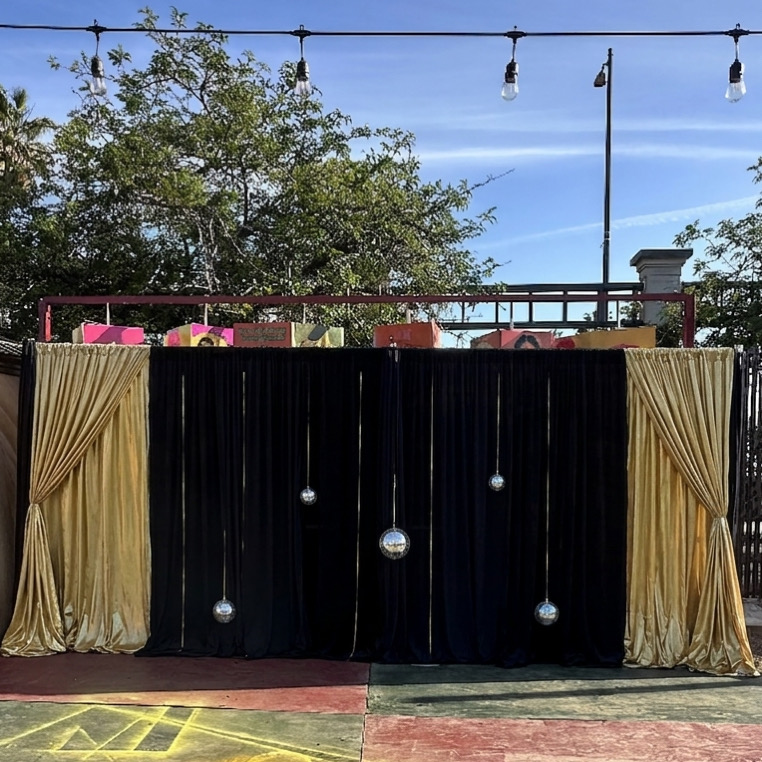 Outdoor black and gold event draping