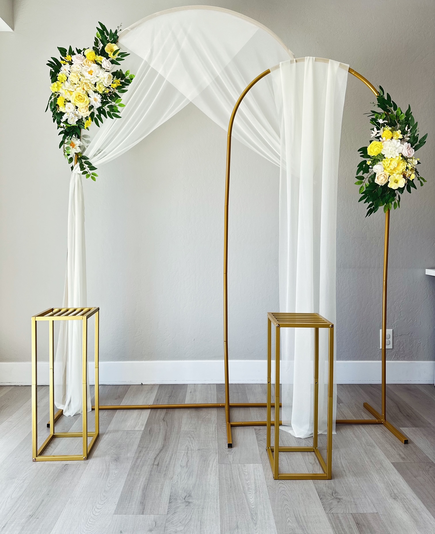 White and yellow floral arch setup