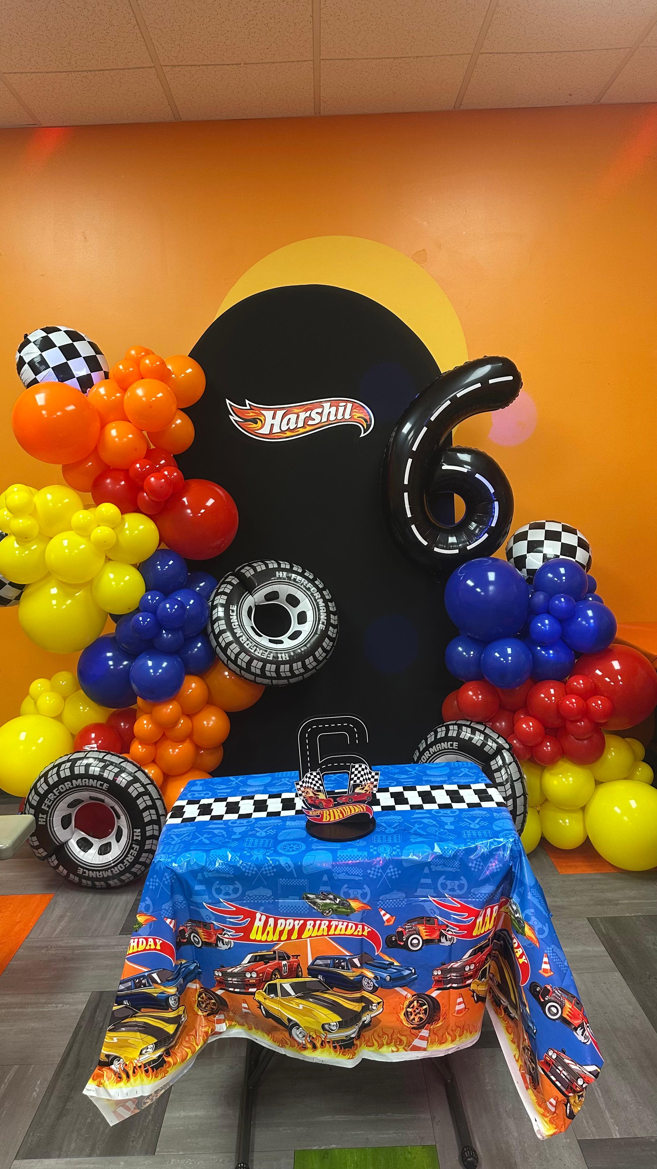 Hot Wheels themed birthday backdrop with colorful balloon decor