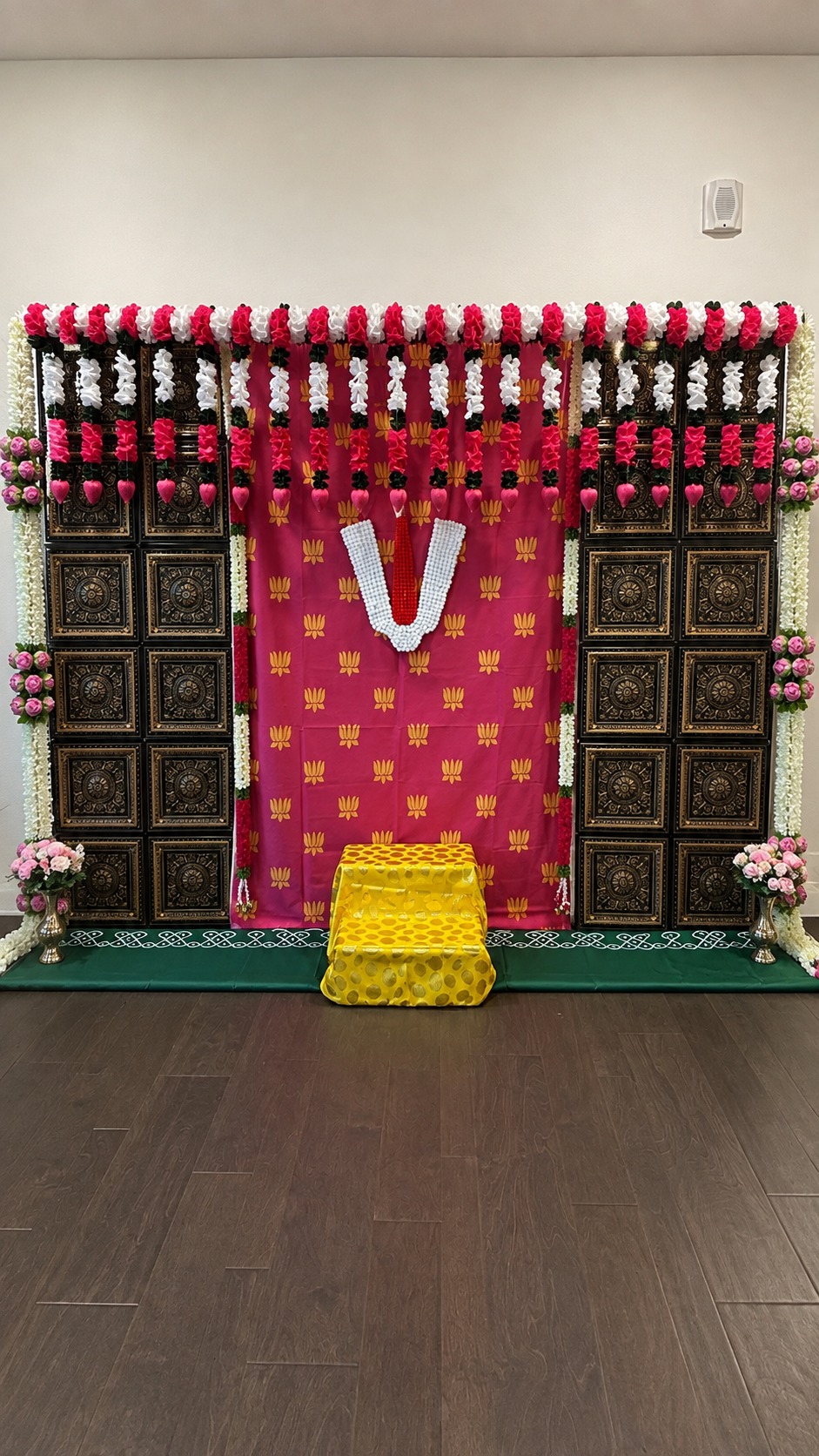Housewarming Vishnu tilak backdrop with floral garlands